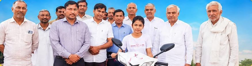 Komal receiving a scooty for scoring 95.2% in Class X