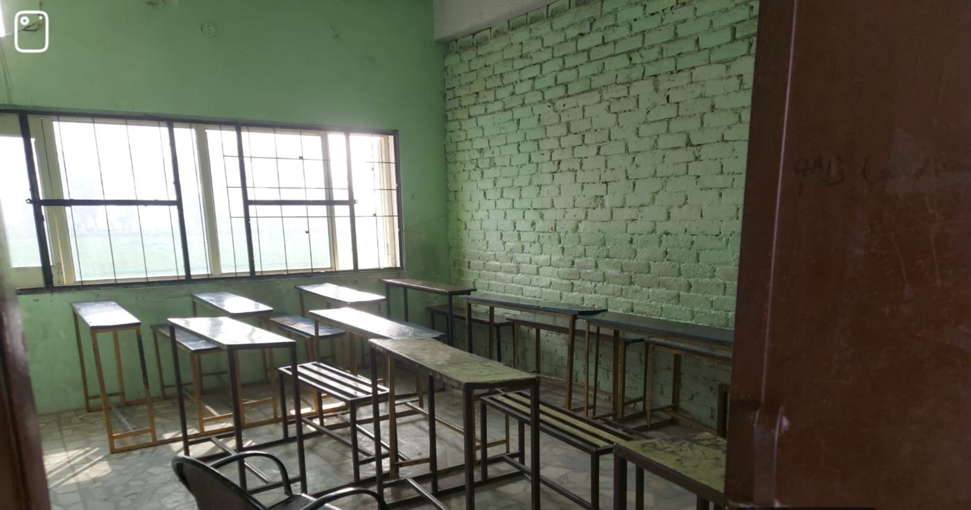 Spacious classroom with desks and benches
