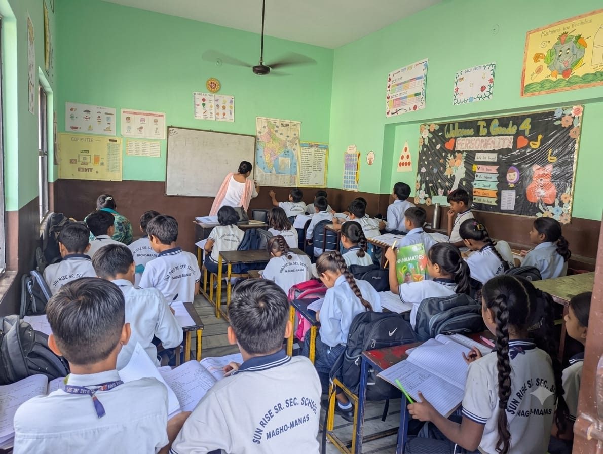 Students studying in a spacious, well-lit classroom at Sun Rise School