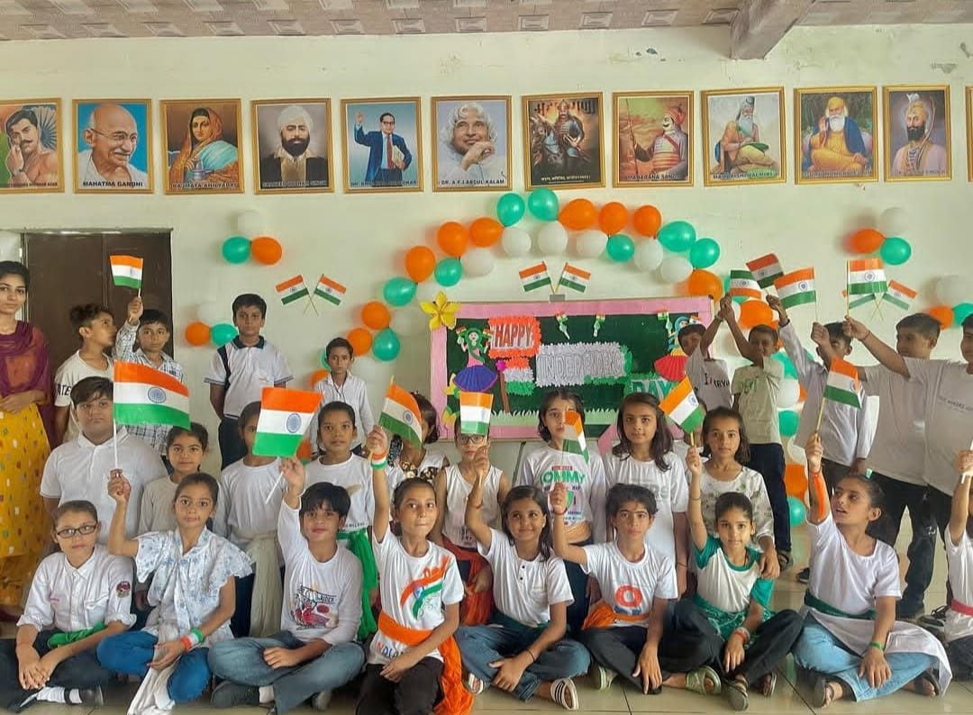 Primary students celebrating Independence Day with flags