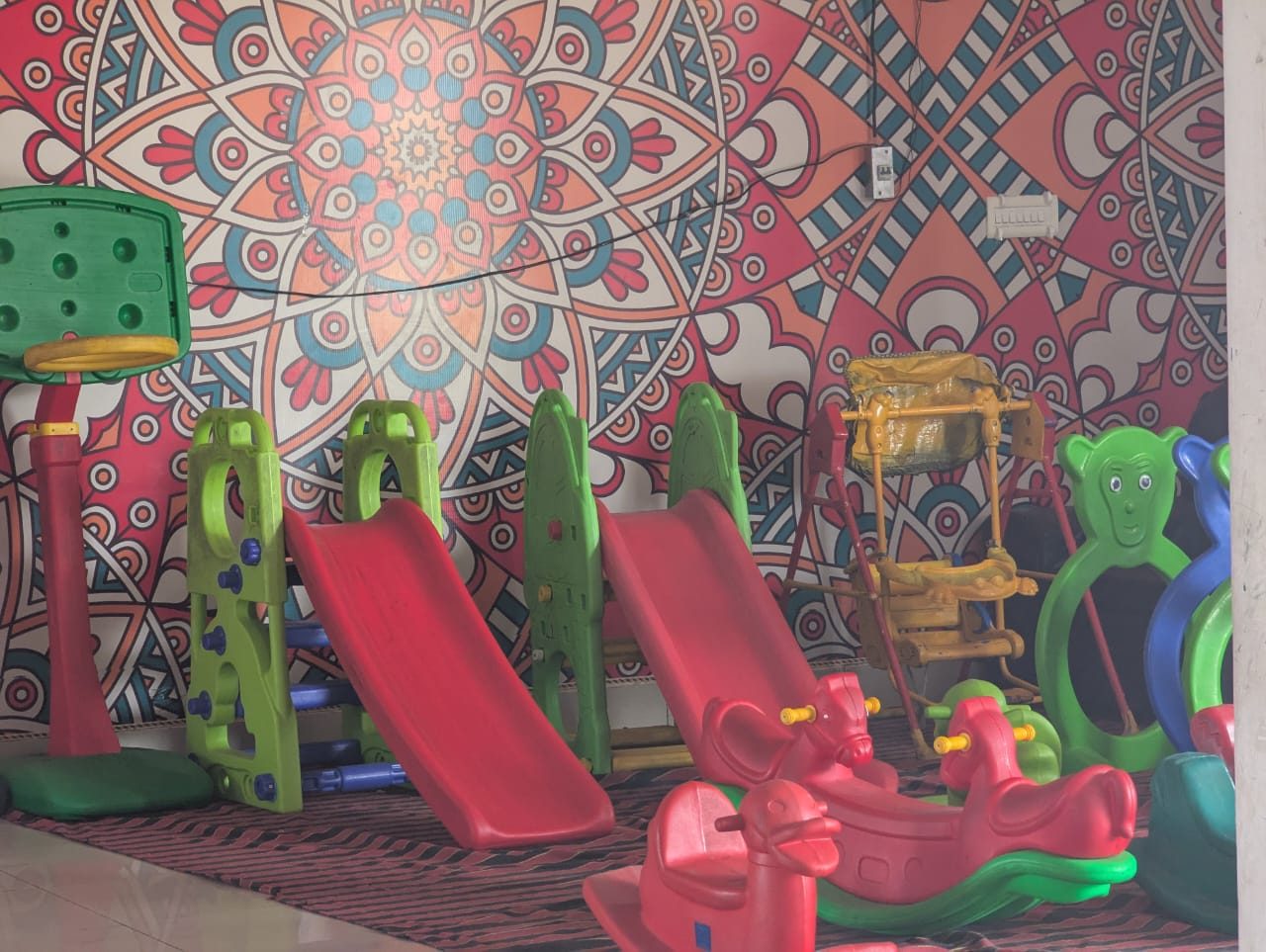 Indoor play zone with slides and rockers for pre-primary children
