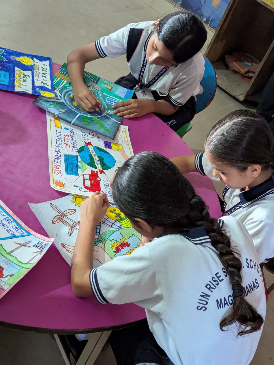 Students painting energy conservation posters
