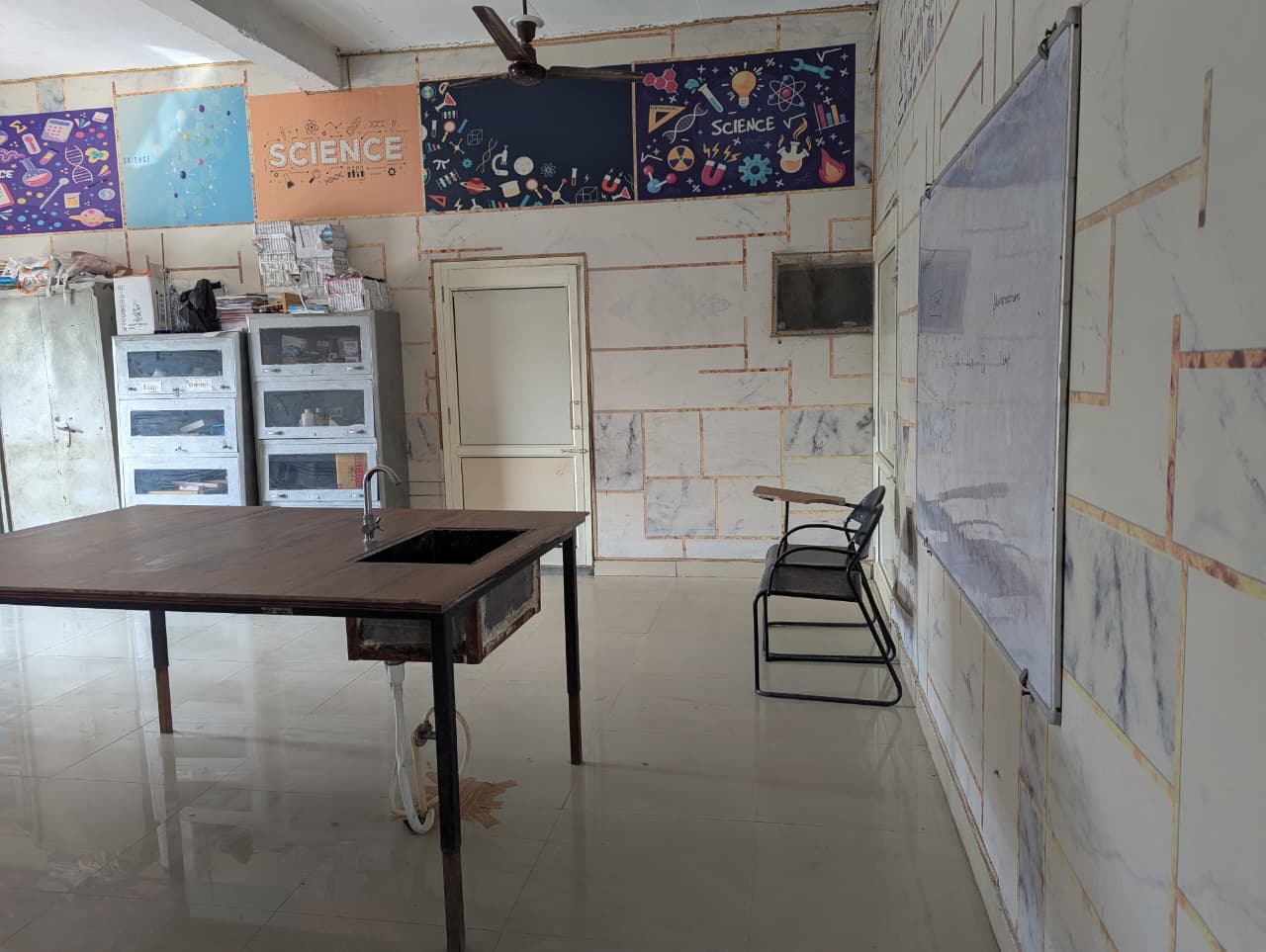 Science laboratory at Sun Rise School with practical table, sink and science charts