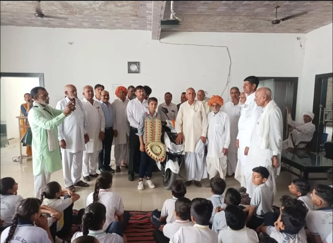 Board topper honoured with a scooty by village elders