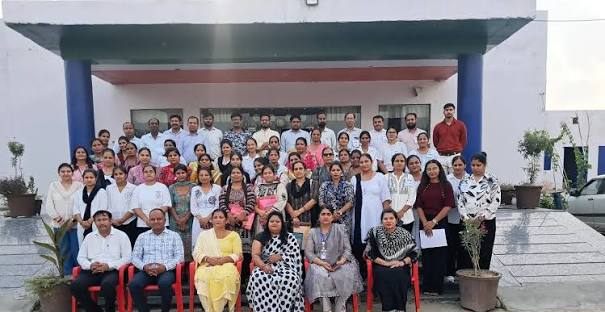 Staff group photograph at the school entrance